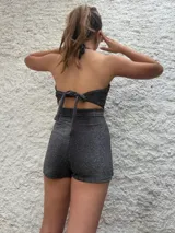 Mono corto plateado con lurex, escote halter y corte cruzado en la falda.