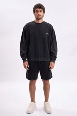 Bermuda de corte recto con efecto lavado en color gris oscuro, confeccionada en tejido de algodón con cintura elástica y cordón de ajuste.