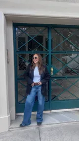 Blazer gris con solapas de muesca, bolsillos con solapa en el frente y un botón de cierre.