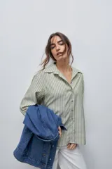 Camisa de manga larga con diseño de rayas verticales blancas y verdes, calce relajado, cuello clásico y botonadura frontal con botones perlados.