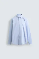 Camisa de corte slim fit confeccionada en tejido de algodón, con cuello italiano, manga larga con puños abotonados y cierre frontal de botones.