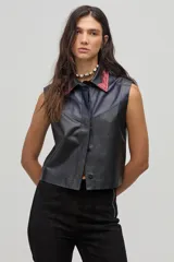 Chaleco negro de cuero con cuello camisero en color borgoña y azul, sin mangas y con cierre frontal de botones.