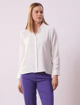 Camisa azul marino de gasa, marca Sioni. Cuello con solapa y abertura central con botones. Manga larga con puño y botón.