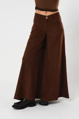 Pantalón marrón acampanado de tiro medio, con bolsillos delanteros y traseros. Cierre frontal con cremallera y botón.