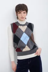 Chaleco de tejido de punto con diseño de rombos multicolor en tonos gris, beige, negro, bordó y celeste. Presenta cuello redondo y terminaciones acanaladas.