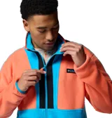 Campera de polar Columbia modelo Backbowl II, con diseño color block en naranja y azul. Presenta cierre frontal completo, cuello alto y bolsillos laterales con cierre.