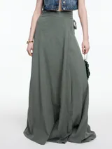 Falda larga color beige, de corte evasé y tiro alto, con lazo ajustable en la cintura.