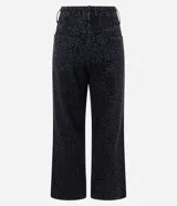 Pantalón de jean con corte recto y largo cropped, de cintura alta. Presenta un diseño estampado con motivo animal print en tonos oscuros, cierre frontal con botón y bolsillos funcionales.