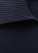 Buzo de lana de punto grueso en color azul marino, con cuello de solapa y diseño recto con aberturas laterales en el bajo.