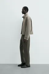 Pantalón chino de corte regular fit, confeccionado en tejido de algodón con elasticidad. Presenta bolsillos frontales, bolsillos traseros de vivo y cierre frontal con cremallera y botón.