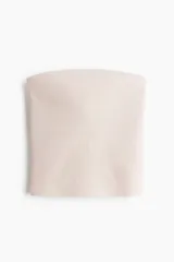 Top strapless de punto acanalado, color beige claro, con forro parcial.