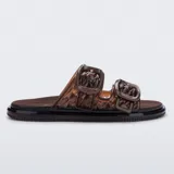 Sandalias Melissa modelo Possession Slip, confeccionadas en material plástico translúcido color marrón, con diseño superior tejido de pescador, dos tiras con hebillas decorativas y suela anatómica con plantilla suave.