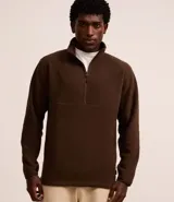 Saco deportivo negro de manga larga, confeccionado en tejido fleece, con cuello alto y cierre frontal parcial de cremallera. Presenta un corte recto y costuras horizontales a la altura del pecho.