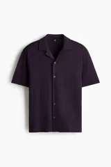 Camisa de manga corta en punto jacquard de mezcla de algodón, color morado, con cuello abierto y cierre frontal de botones.
