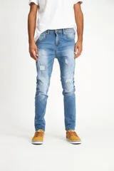 Jean celeste con efecto lavado y roturas en las rodillas, de corte ajustado.