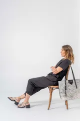 Sandalias de cuero negro con tiras finas cruzadas, taco cuadrado y hebilla lateral.