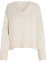Sweater Calvin Klein de punto de algodón color beige, con escote en V, mangas largas y puños, cuello y dobladillo con punto canalé.