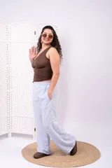 Pantalón tiro alto de pierna ancha, color celeste, con cintura elastizada y bolsillos laterales.