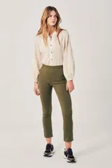 Pantalón ajustado color verde oliva, tiro alto, con costuras frontales marcadas y largo al tobillo.