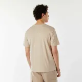 Camiseta beige de manga corta con estampado frontal en negro que dice "SYDNEY AUSTRALIA".