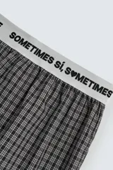 Bóxer de popelín con estampado a cuadros en blanco, negro y líneas finas rosadas. Cintura elástica ancha de color blanco con texto negro que dice "SOMETIMES BYE SOMETIMES SÍ, SOMETIMES".