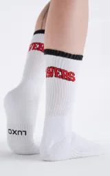 Medias 3/4 de algodón color blanco, con borde superior negro y el logo 'RAVERS' bordado en color rojo.