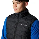 Chaleco acolchado de plumón Columbia, color negro, con cierre frontal completo, cuello alto y bolsillos laterales con cierre. Presenta tecnología HeatSeal™ de construcción sellada térmicamente y forro termorreflectante Omni-Heat™.