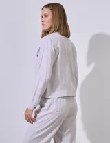 Camisa tipo campera de lino marca Dash, color blanco, con cierre frontal de botones, cuello camisero y bolsillos con solapa en el pecho.