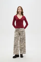 Remera de manga larga color bordó, con escote en V profundo y corte ajustado al cuerpo.