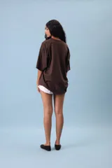 Remera oversize color lila con estampado frontal de un óvalo con la frase "Chill Peel" en marrón.