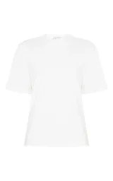 Remera blanca Le Lis Blanc confeccionada en punto de algodón, de corte recto y holgado, con escote redondo, mangas cortas amplias y detalle de abertura en la espalda.