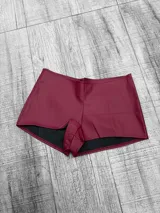 Short de cuero sintético color borgoña, tiro bajo y corte ajustado.