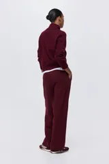 Pantalón deportivo de felpa color bordó, de corte recto y tiro mid-rise con cintura elástica.