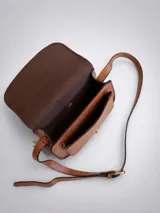 Bandolera de tamaño pequeño en color camel con acabado texturizado. Presenta un diseño de solapa frontal con detalle de hebilla decorativa y cierre magnético. Incluye una correa larga ajustable y herrajes metálicos en tono dorado.