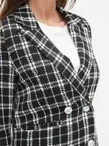 Blazer marrón con estampado a cuadros, doble botonadura y solapas de muesca.