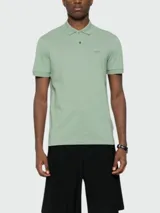 Polo de manga corta color verde menta, confeccionado en piqué de algodón, con cuello y tapeta de tres botones. Presenta un logo bordado tono sobre tono en el pecho.