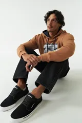 Canguro de felpa modelo Handel, color tostado, con capucha ajustable con cordones oscuros, bolsillo frontal tipo canguro y estampa gráfica inspirada en la Creación de Adán con la leyenda "Renaissance" y branding de Mistral.