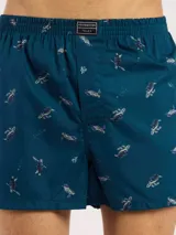 Bóxer de algodón blanco con estampado de flores pequeñas color celeste, con cintura elástica y logo de la marca en el centro.