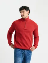 Sweater de punto inglés color verde, con cuello alto y cierre frontal parcial metálico. Diseño de manga larga con puños y ruedo acanalados.