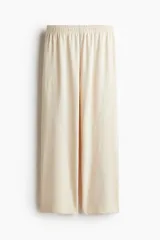 Pantalón de jogging color crema, de corte recto y cintura elástica.