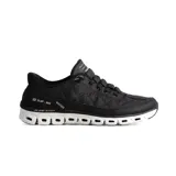 Championes deportivos Skechers Slip-ins Glide-Step, color negro con entresuela blanca geométrica. Presentan un diseño acolchado con tecnología Hands Free Slip-ins, plantilla Air-Cooled Memory Foam y cordones elásticos decorativos.