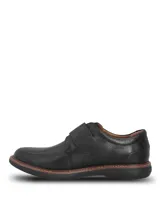 Zapatos de cuero negro Hush Puppies modelo Iowa, con cierre de tira de velcro en el empeine, costuras visibles en la suela y suela de goma EVA.