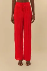 Pantalón plisado rojo de tiro alto, con corte ancho y pretina elástica con cordón ajustable.