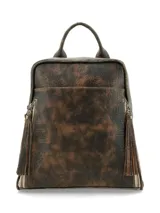 Mochila Hush Puppies modelo Saba, color marrón con efecto desgastado, asa superior y tiras de flecos decorativos en los cierres laterales.
