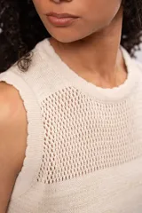 Vestido corto color crema, tejido a crochet con lurex, sin mangas y cuello redondo.