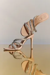 Sandalias de tacón alto PatBO modelo Dalva, de color nude con tiras cruzadas decoradas con cristales de imitación y tacón fino.