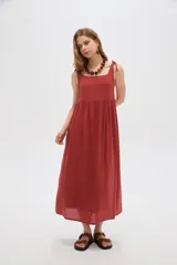 Vestido midi negro de viscosa con cuello cuadrado y tirantes finos ajustables con lazo en los hombros, de corte holgado y diseño fluido.