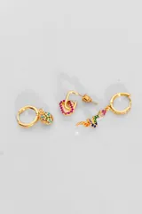 Set de tres pares de aros dorados. Un par es tipo argolla con dije de flor con incrustaciones de strass de colores. Otro par es tipo argolla con forma de corazón con incrustaciones de strass fucsia. El tercer par es tipo argolla con incrustaciones de strass blancos y dije de serpiente con incrustaciones de strass de colores.