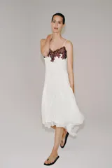 Vestido midi blanco de la ZW Collection con escote en V, tirantes finos, bajo asimétrico y detalle de aplicación de encaje a contraste en el escote.