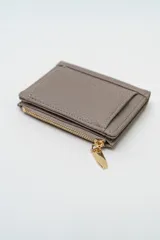 Billetera de cuero sintético texturizado color marrón, con cierre metálico dorado y solapa frontal.
